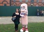 A picture of Alice Rose standing with a giant sausage person at the sausage