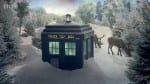 Photo: BBC via Google. The Doctor's big blue box, the TARDIS is covered in snow. It is surrounded by trees and snow.